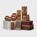 Collection of Indian handicrafts featuring hand-painted pottery, embroidered textiles and carved wooden figurines